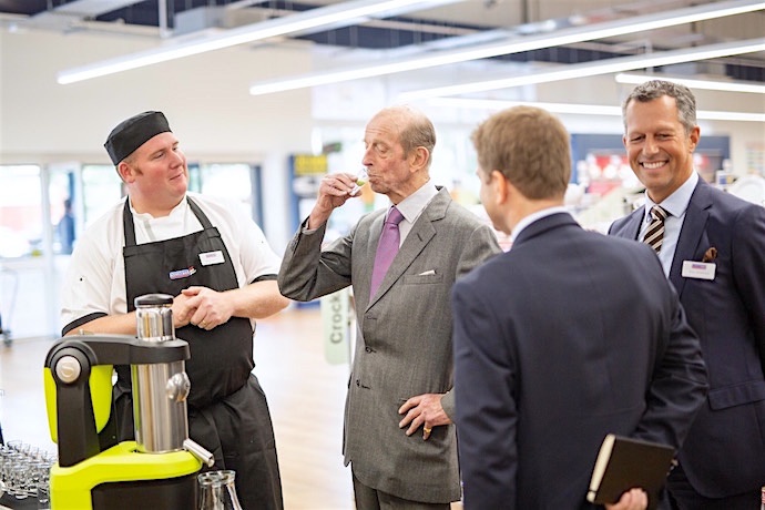 HRH samples a freshly produced juice using state of the art machinery at Nisbet Catering